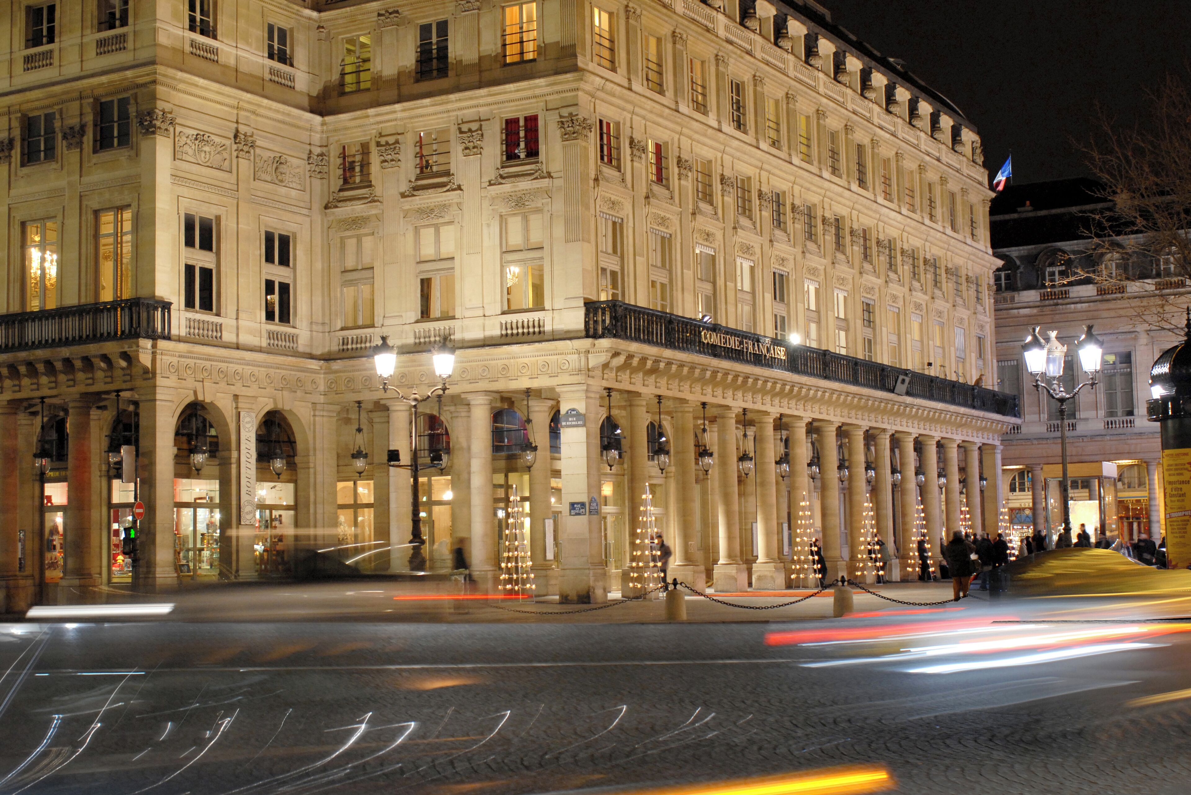 A historic building with classical architecture, featuring columns, arched windows, and ornate detailing.