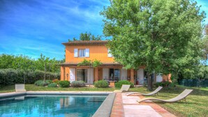 A two-story house with a swimming pool and lounge chairs. -  The Vignaux bastide (Grimaud)