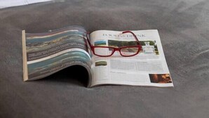 A bed with a magazine and glasses on it. - Glebe Street Apartment (Fife)