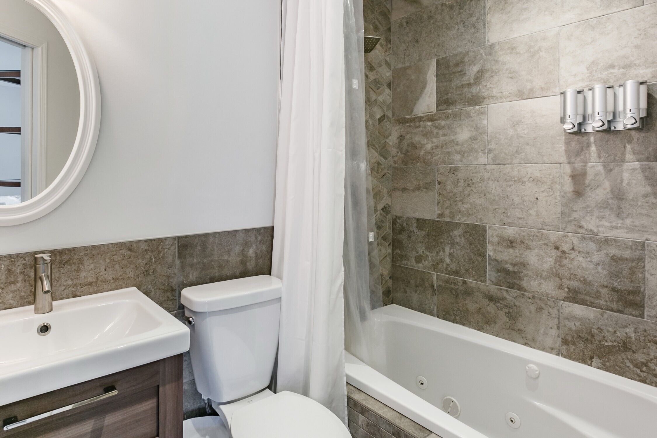 A bathroom with a sink, toilet, and bathtub.
