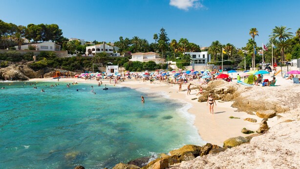 A beach with clear turquoise water, people swimming, and umbrellas. - MIRADORBEACH-1ºlínea Playa-Wifi y Garaje Gratis. (Calpe / Calp)