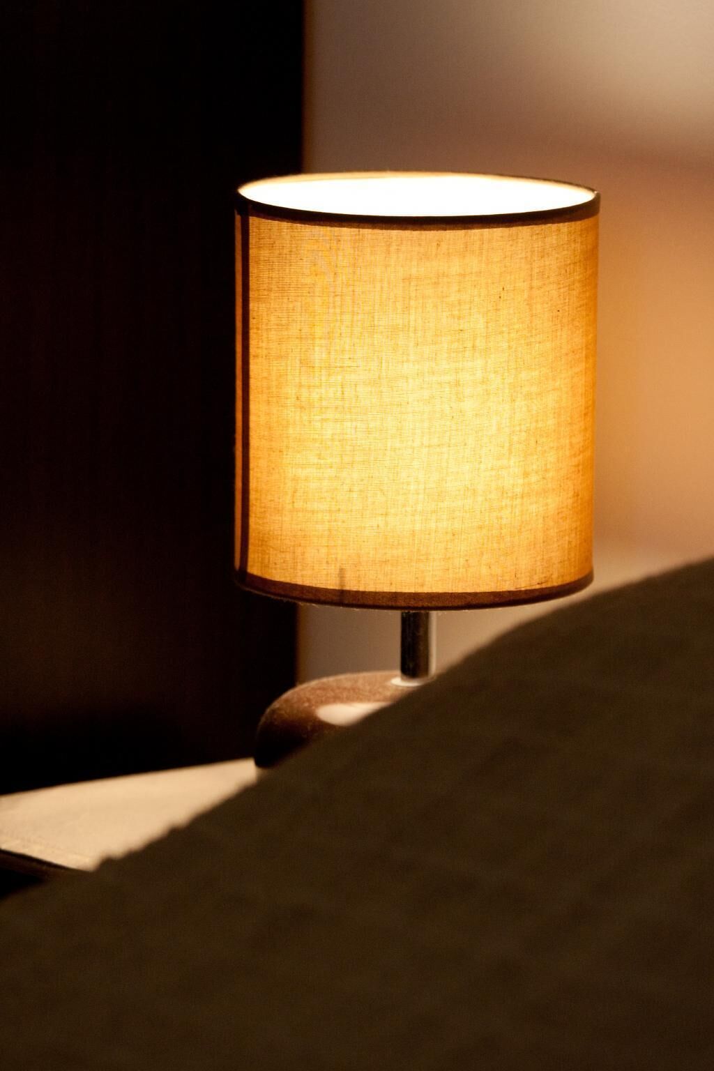 A table lamp with a fabric shade on a table.