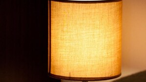 A table lamp with a fabric shade on a table. - Apartments Briest - Studio Apartment (Dubrovnik)