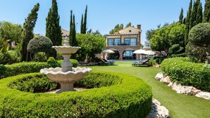 A modern house with a pool and a well-maintained garden.