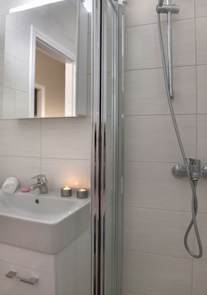 Shower, hair dryer, towels, soap