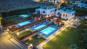 A modern villa with two swimming pools, a well-maintained garden, and a paved patio area. - Lindos Topaz - Two Bedroom Villa, Sleeps 4 (Lindos)