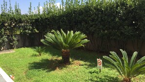 A garden with palm trees and a sign prohibiting entry. - Salieri Apartment 2 bedrooms (Latina)