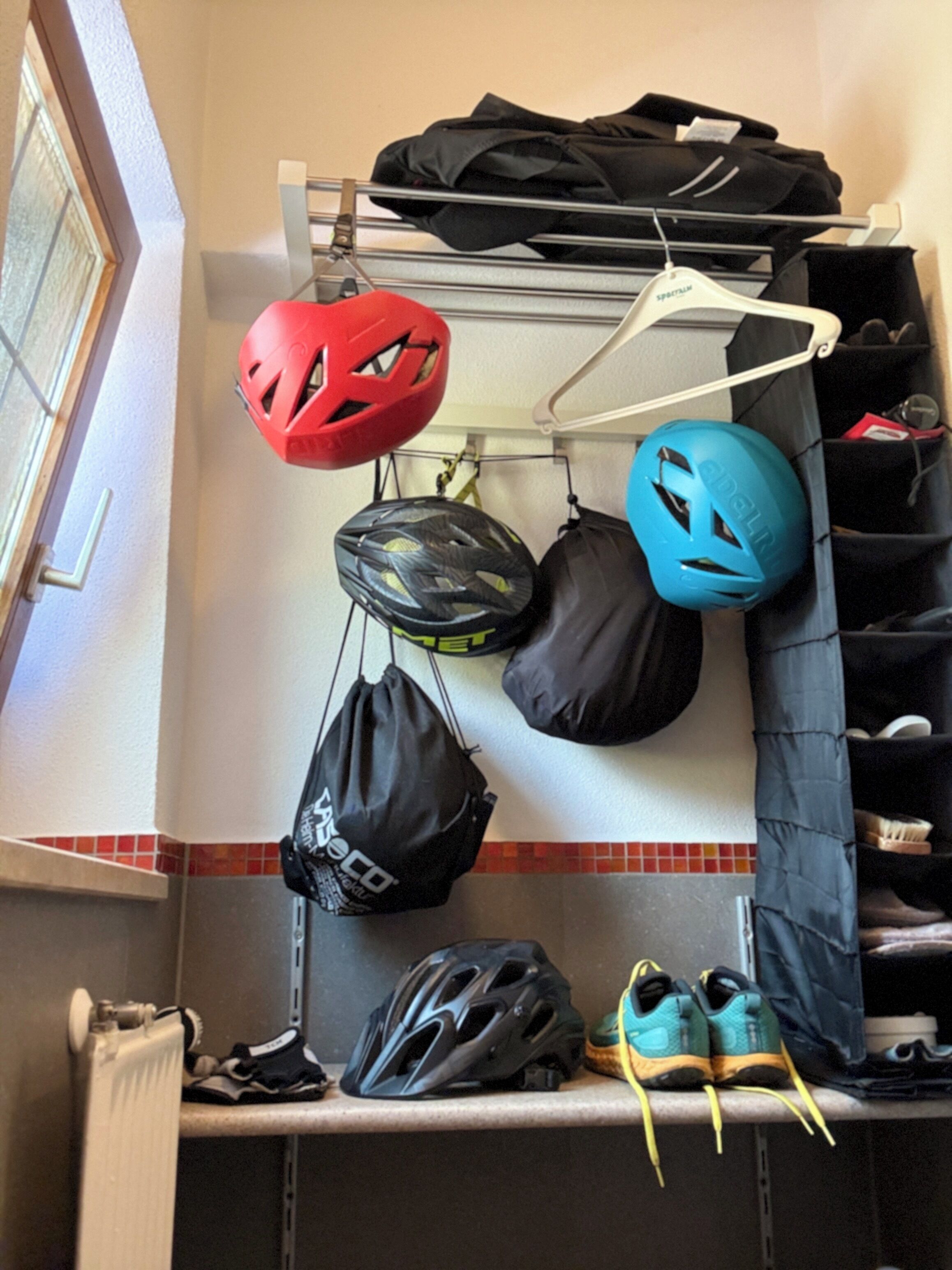 A storage area with helmets, bags, and shoes.