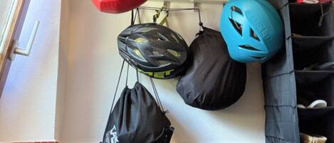 A storage area with helmets, bags, and shoes.