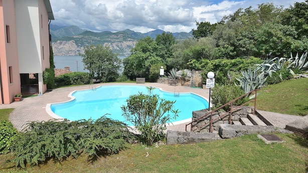 A swimming pool with a view of mountains and a building in the background.