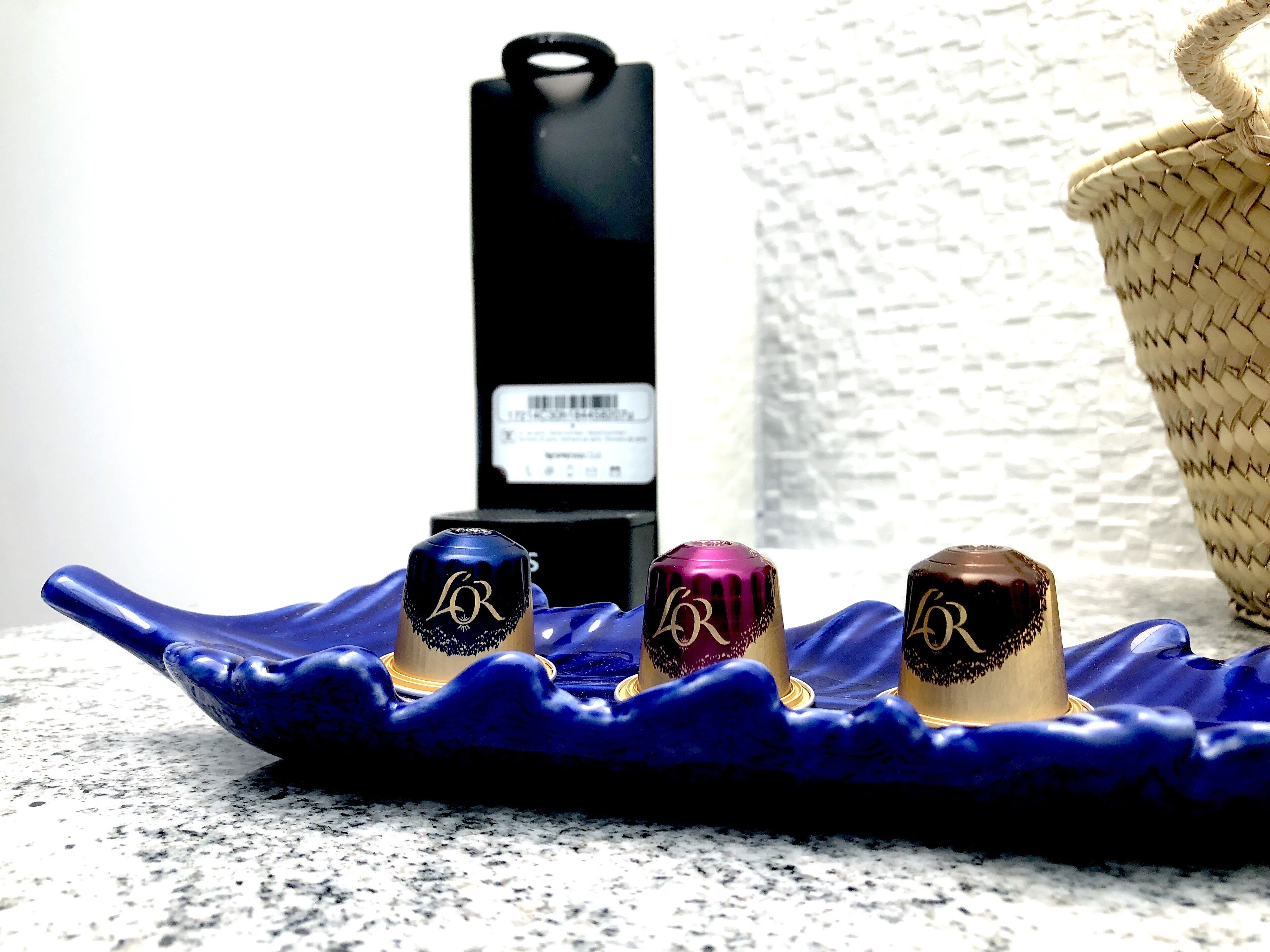 Three bottles with a logo on a blue tray.