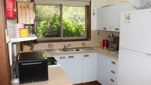 A compact kitchen with a sink, a coffee maker, and a microwave. - Church St - Conveniently Located in the Hart of Bright (Bright)