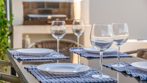 An outdoor dining area with tables set for two, each with a plate, two wine glasses, and a napkin. - CASA HECTOR - Villa with private pool in Cala d'Or. Free WiFi (Santanyí)