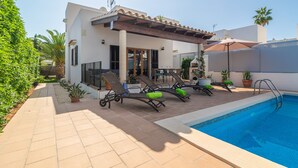 A modern poolside area with lounge chairs, a pool, and a patio with potted plants. - CASA HECTOR - Villa with private pool in Cala d'Or. Free WiFi (Santanyí)