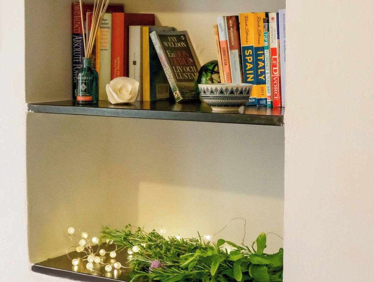A bookshelf with books and decorative items.