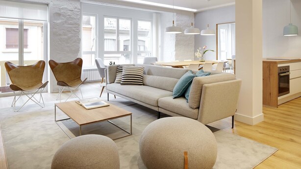 A modern living room with a sofa, armchairs, a coffee table, and a dining area with a table and chairs. - Marugame by FeelFree Rentals (San Sebastián)
