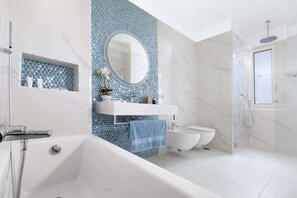 Bathtub, hair dryer, bidet, towels