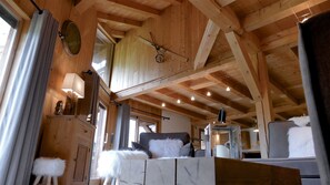 Un interior de madera con techos altos, vigas a la vista y un estilo rústico.