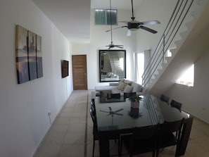 Enjoy meals in the dining area with a glass-top table and comfortable seating.
