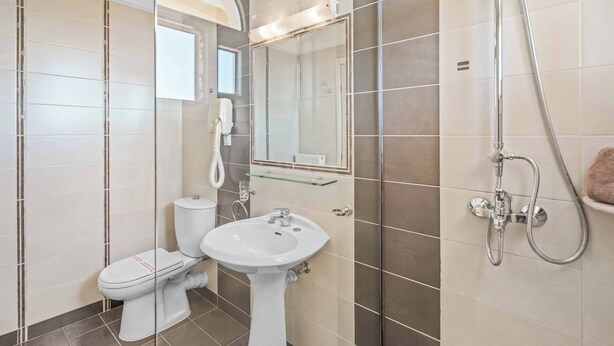 A modern bathroom with a toilet, sink, and shower. - Villa Sivilla - Four Bedroom Villa, Sleeps 8 (Nisaki)