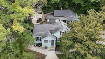 A residential property with a two-story house, a covered porch, and a driveway.