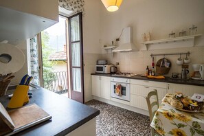 A kitchen with a microwave, oven, and various kitchen items on the counter.