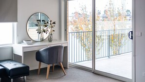 A modern room with a desk, chair, and a large window with a view of a balcony. - Waterfront Grand Villa in Sanctuary Lakes (Point Cook)