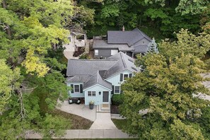 A residential property with a two-story house, a covered porch, and a driveway. - The Oriole, hot tub, walk or Bike to Saugatuck! (Saugatuck)