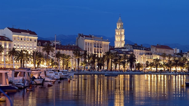 A marina with boats docked, a prominent tower, and buildings along the waterfront. - Luxury family-friendly apartment with private pool, 10 min drive to center Split (Solin)