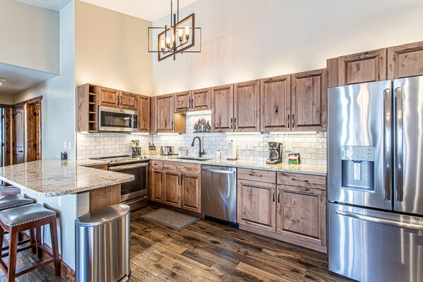 Enjoy cooking in this well-equipped kitchen with a large island and stainless steel appliances.