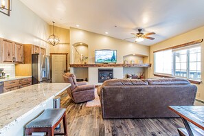 Relax in the living area with a sofa, armchair, and fireplace.