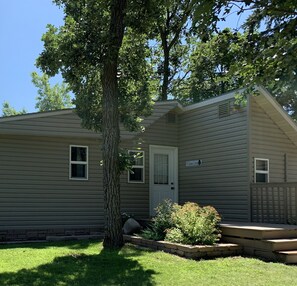 A single-story house with a front door, two windows, and a small porch. - Hollys Resort (Battle Lake)