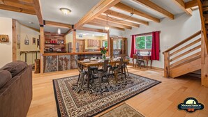 A spacious living area with a wooden ceiling, a dining table set for four, and a cozy sofa. - Fishing pond, 15 minutes to Nashville (Nashville)