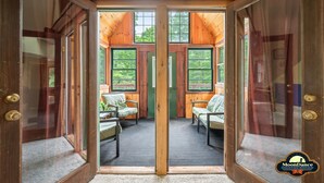 A wooden cabin with a central door leading to a seating area with two chairs and a bench. - Fishing pond, 15 minutes to Nashville (Nashville)