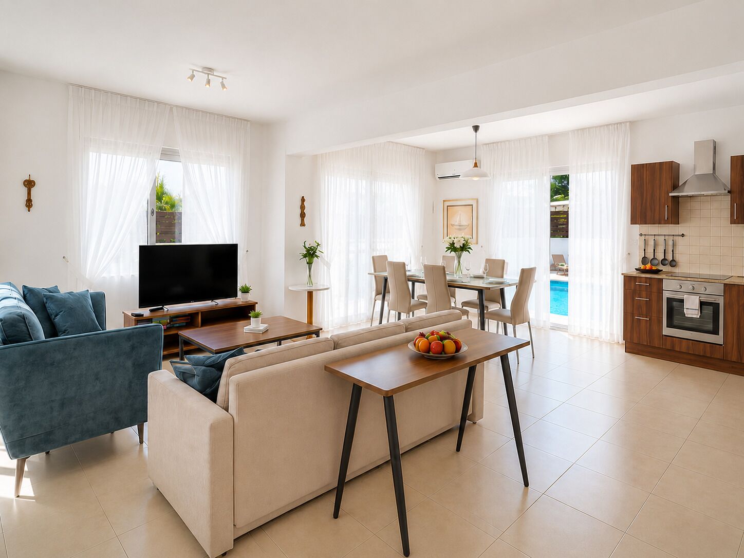 A modern living room with a sofa, TV, and dining area.