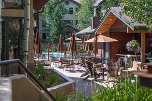 Relax by the pool surrounded by lush greenery and comfortable seating areas.