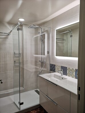 Shower, hair dryer, slippers, towels