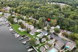 An aerial view of a residential area with houses, a marina, and a swimming pool. - Screened porch pt water views hot tub walk to Saug (Saugatuck)