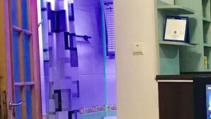 A bathroom with a toilet, a shower curtain, and a calendar on the wall. - Andreti  Studio Circus Park (Sector 2)