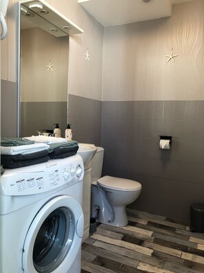 Bathtub, hair dryer, towels, soap