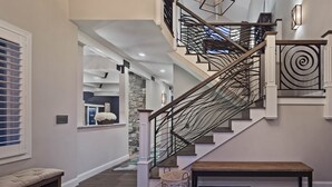 A modern staircase with a unique spiral design, leading to a second floor.