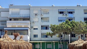 A multi-story building with balconies, air conditioning units, and a green facade. - Fantastic Beach View at ARIEL’s HOUSE (Durrës)