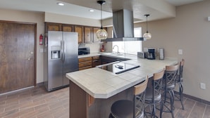 A modern kitchen with a large island, stainless steel appliances, and bar stools. - 2 Mi to Lake Havasu: Private Oasis w/ Pool & Views (Lake Havasu City)