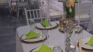 A banquet hall with round tables set for dining, featuring white chairs and green napkins. - Pizo Lodge (Kabwe)