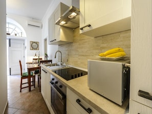 Enjoy cooking in this well-equipped kitchen with a central island, stove, and ample storage.