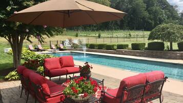 Seasonal outdoor pool, open 10:00 AM to 10:00 PM, pool umbrellas