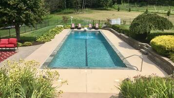 Seasonal outdoor pool, open 10:00 AM to 10:00 PM, pool umbrellas