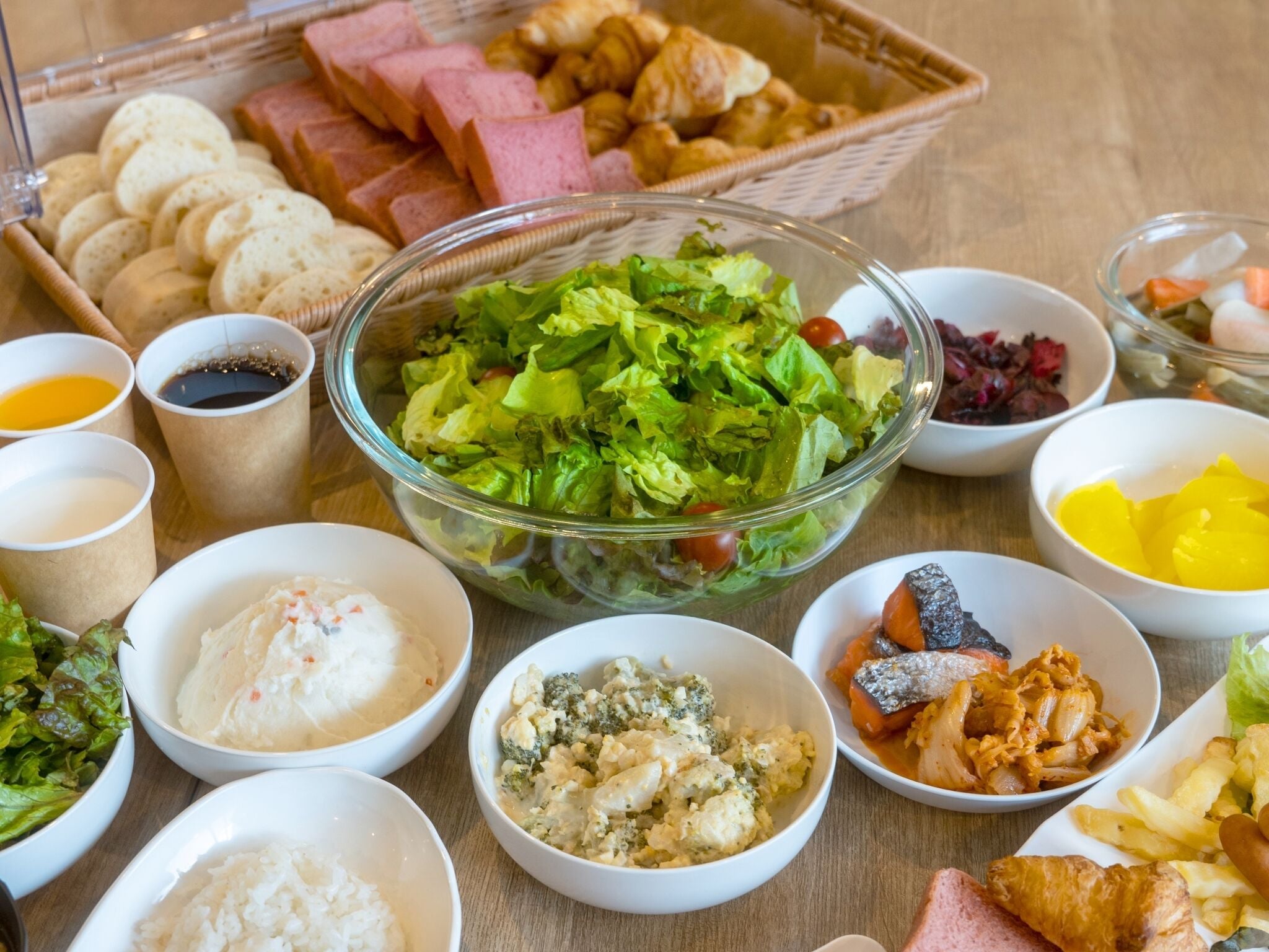 A variety of food items including a salad, rice, and bread.