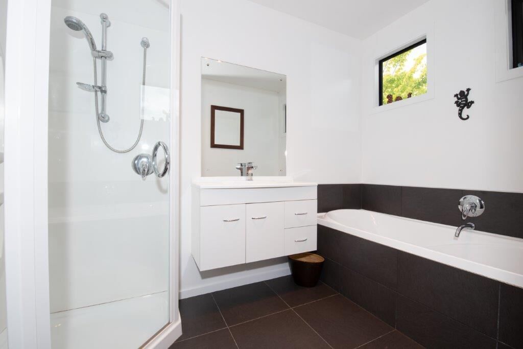 Bathtub, hair dryer, towels, toilet paper