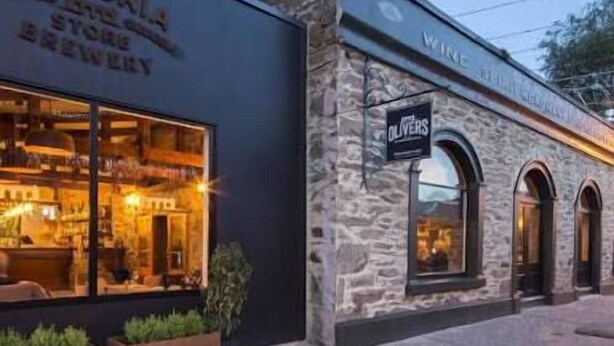 A building with a sign for 'The Victoria Store & Brewery' and 'Olivers Wine Bar & Restaurant'. - Clyde Gem (Clyde)